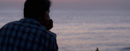 man overlooking ocean