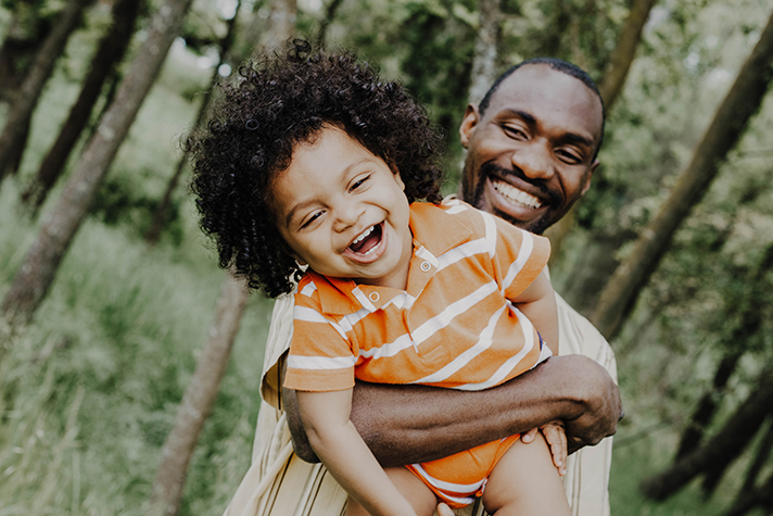 Man holding child and laughing