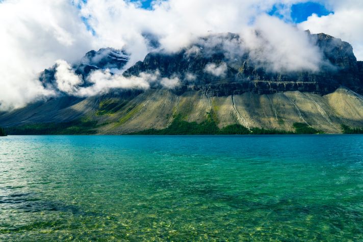 a body of water with mountains behind