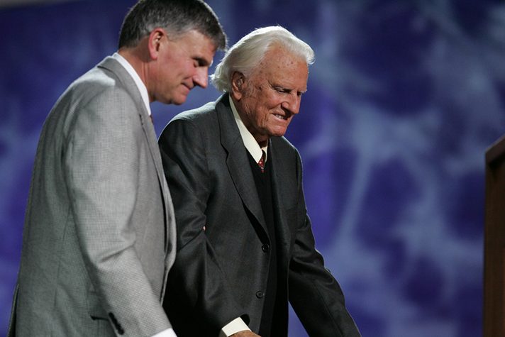 Franklin Graham helping elderly Billy Graham