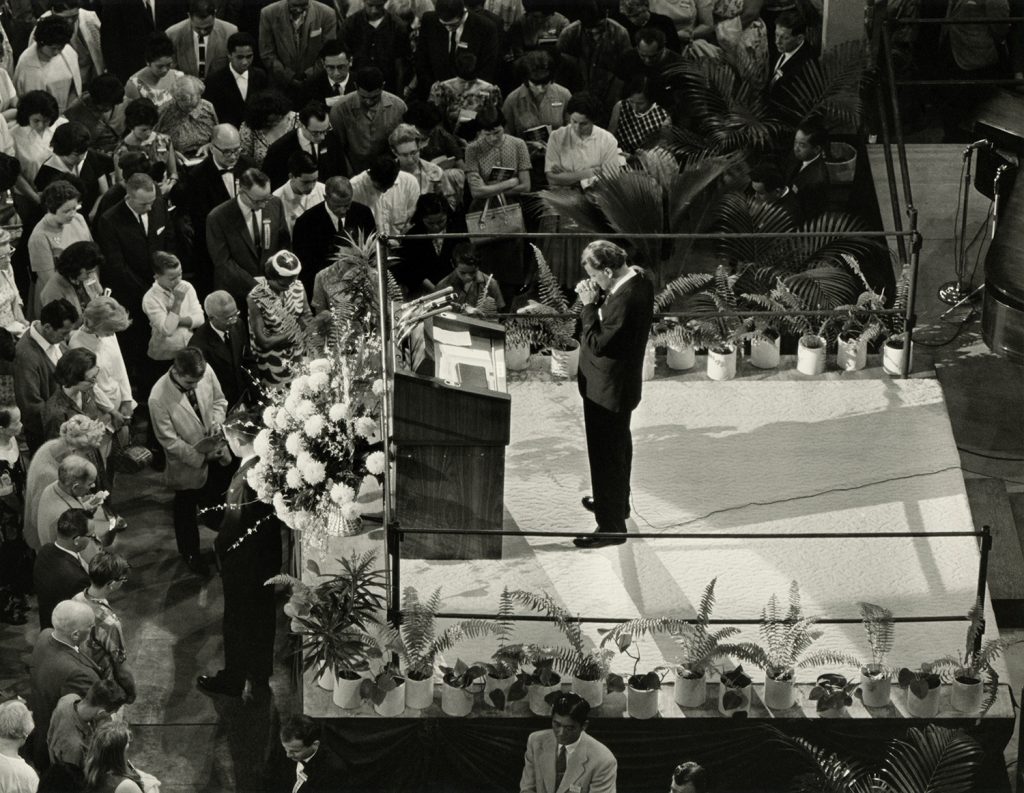 Billy Graham praying onstage