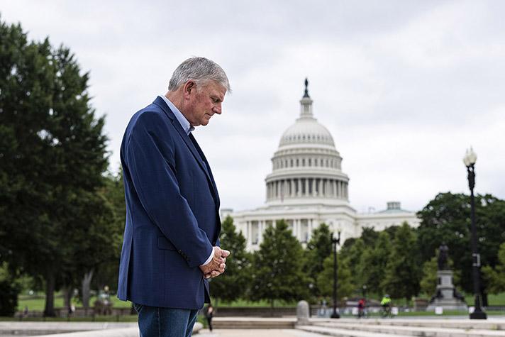 Franklin Graham praying in front of Capitol