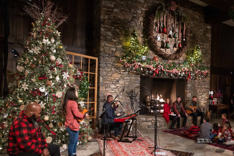 Large stone fireplace, Christmas tree, participants