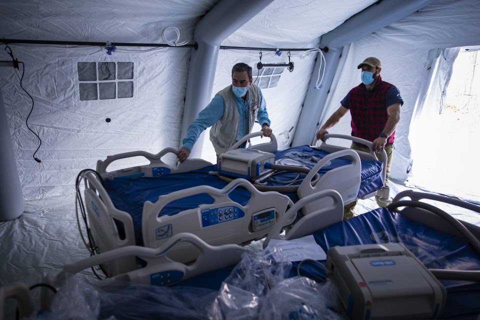 Men moving hospital bed