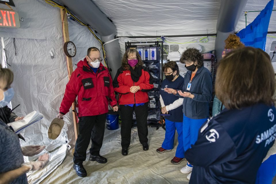 BG-RRT chaplains praying with Samaritan's Purse medical staff