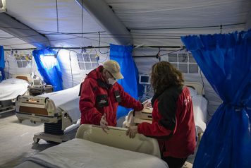 Chaplains pray over hospital beds