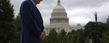Franklin Graham prays with U.S. Capitol in background