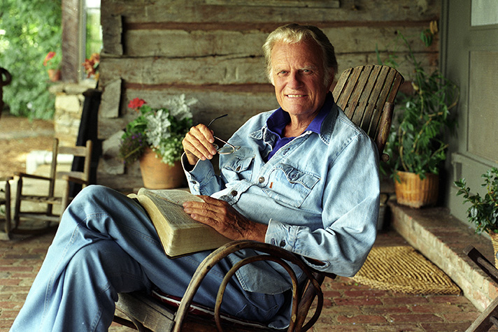 Billy Graham smiling in a rocking chair