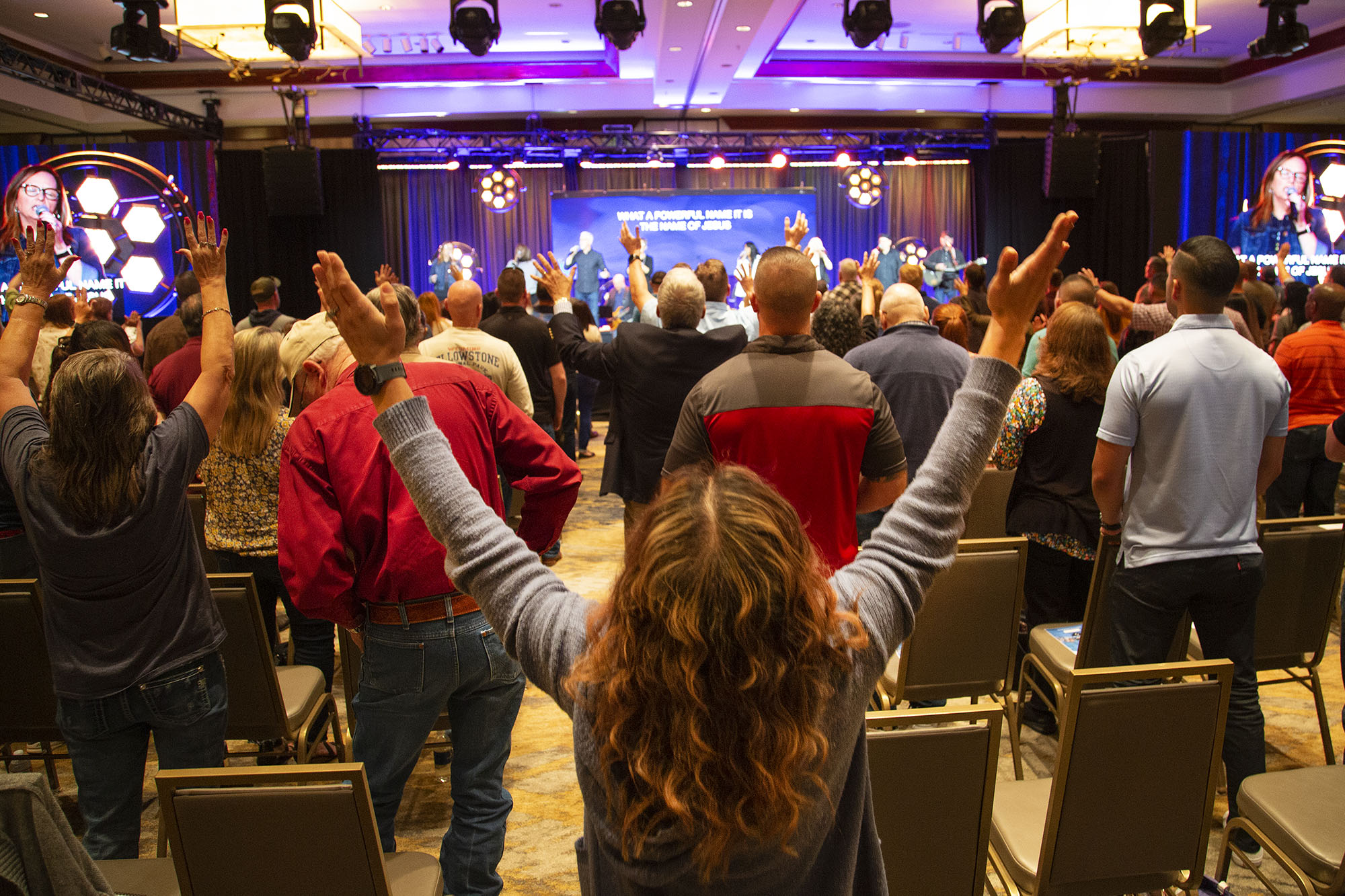 Woman with hands raised in worship