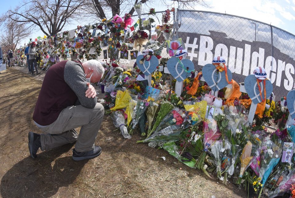 Man knelt down on one knee by memorial