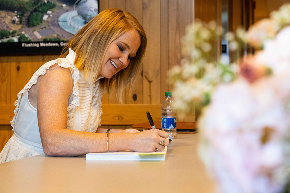 Adrienne Camp signs a book
