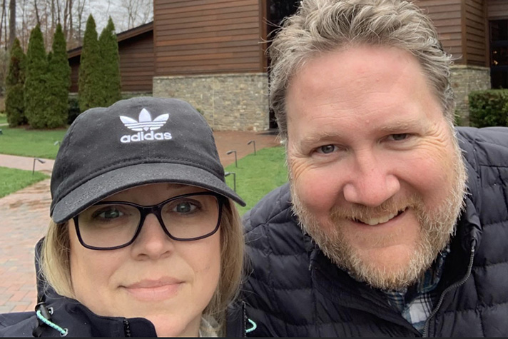 Woman and man posing for picture in front of Billy Graham Library