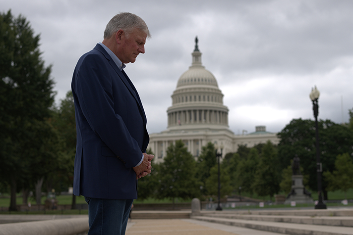 Franklin Graham prays in front of U.S. Capitol
