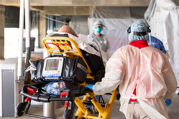 Patient on stretcher being taken into Samaritan's Purse emergency field hospital