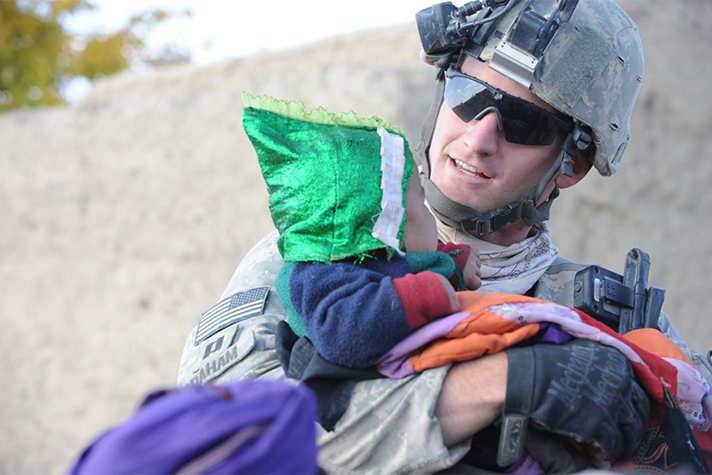 Edward Graham holding Afghan child