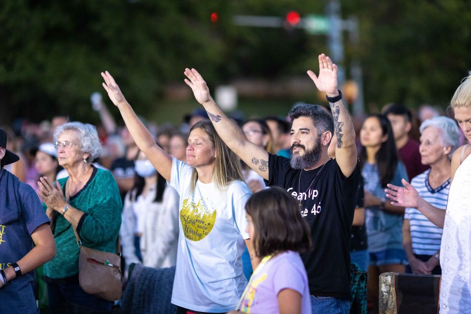 Couple raising hands in worship