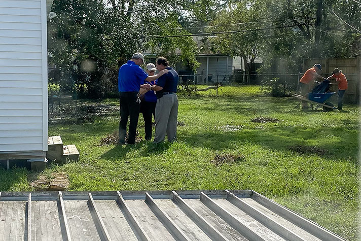 Chaplains Paul and Cindy Bernhart pray with Officer Michael Alwert