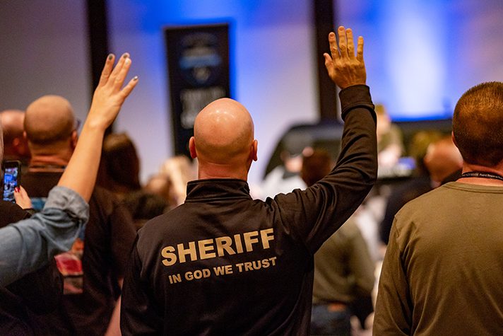 sheriff with hand raised