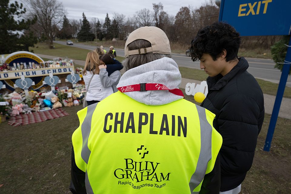 chaplain prays with student