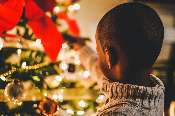 child with Christmas tree