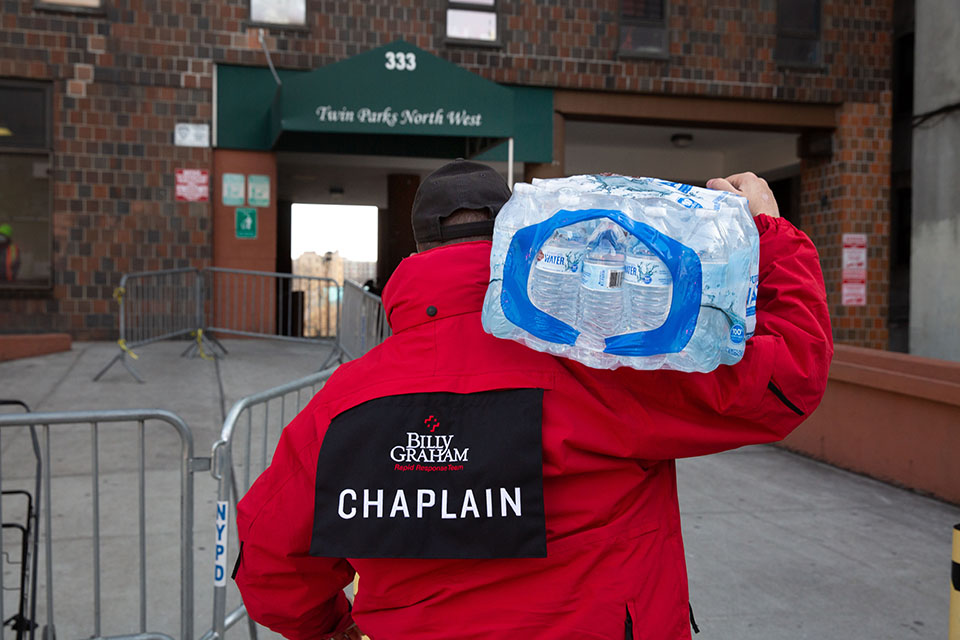 chaplain carrying water bottles