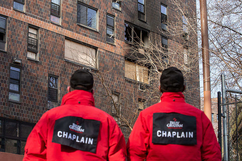 chaplains look at burned building
