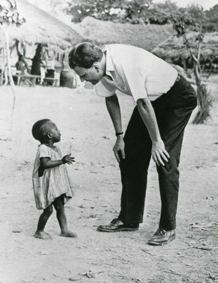 Billy Graham leaning down to child