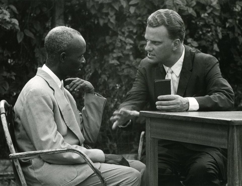 Billy Graham talking with man
