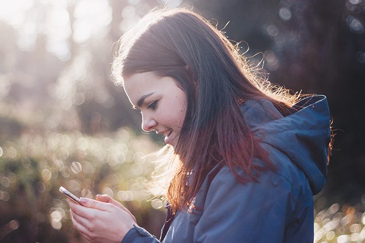 women looks at phone