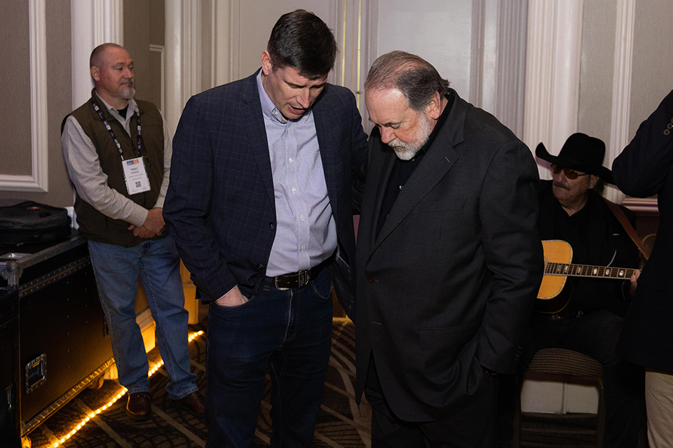 Will Graham praying with Mike Huckabee