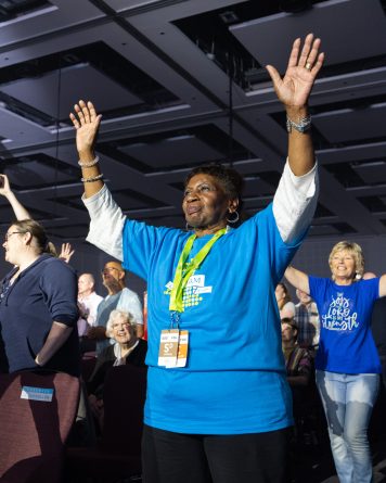 woman with hands raised