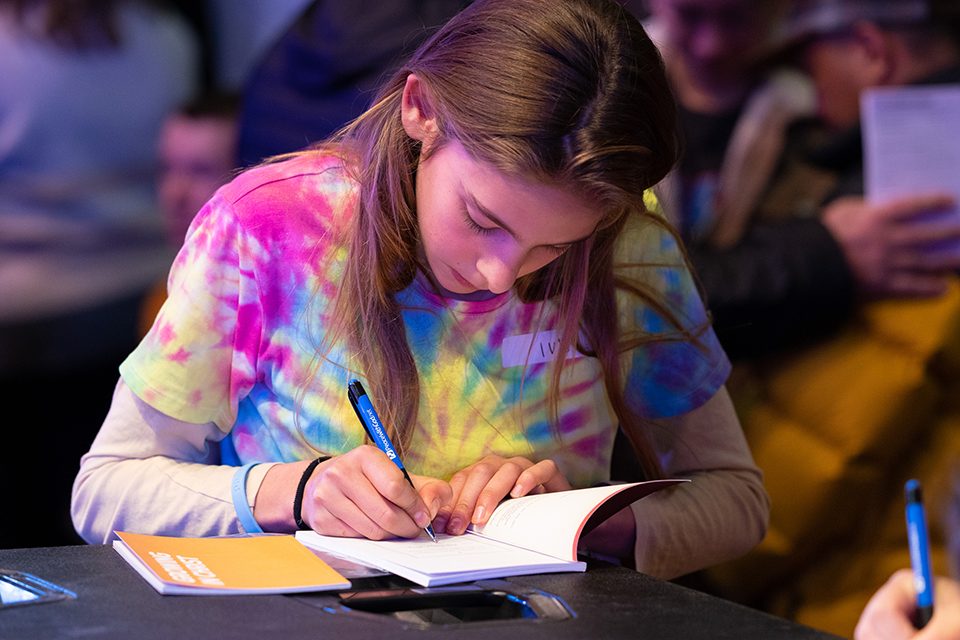 girl signing book
