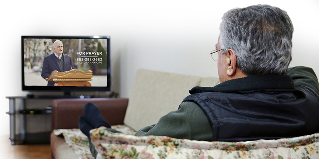 Senior man watching TV