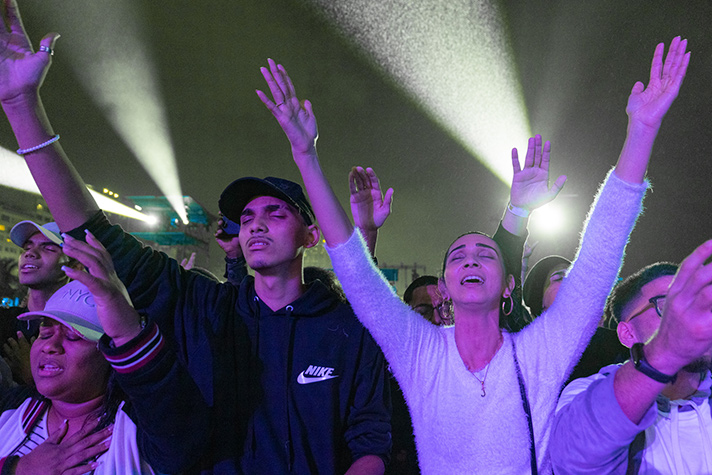 woman and man with hands raised