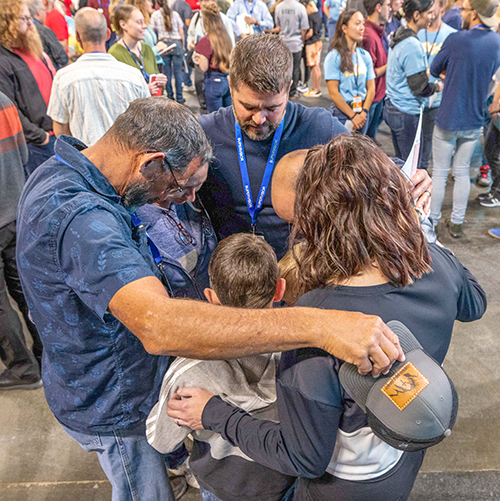 Group praying at the Look Up Tour.