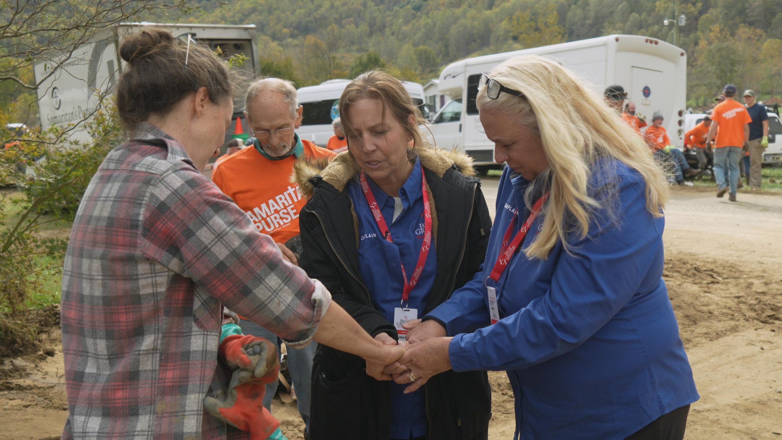 Chaplains praying with woman.