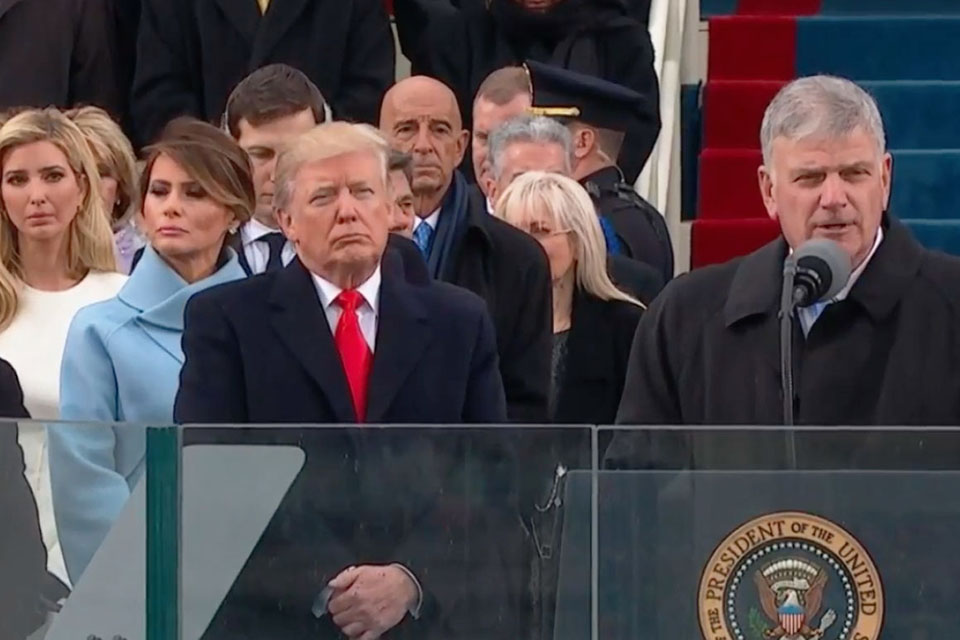 President Donald Trump listens as Franklin Graham reads a passage of Scripture during the inaugural ceremony in Washington, D.C.