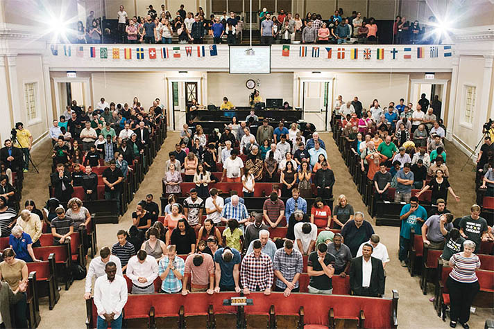 people praying together in church