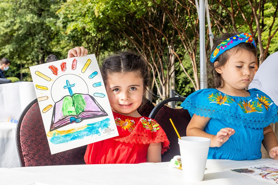 Two little girls coloring at Hispanic Heritage Day