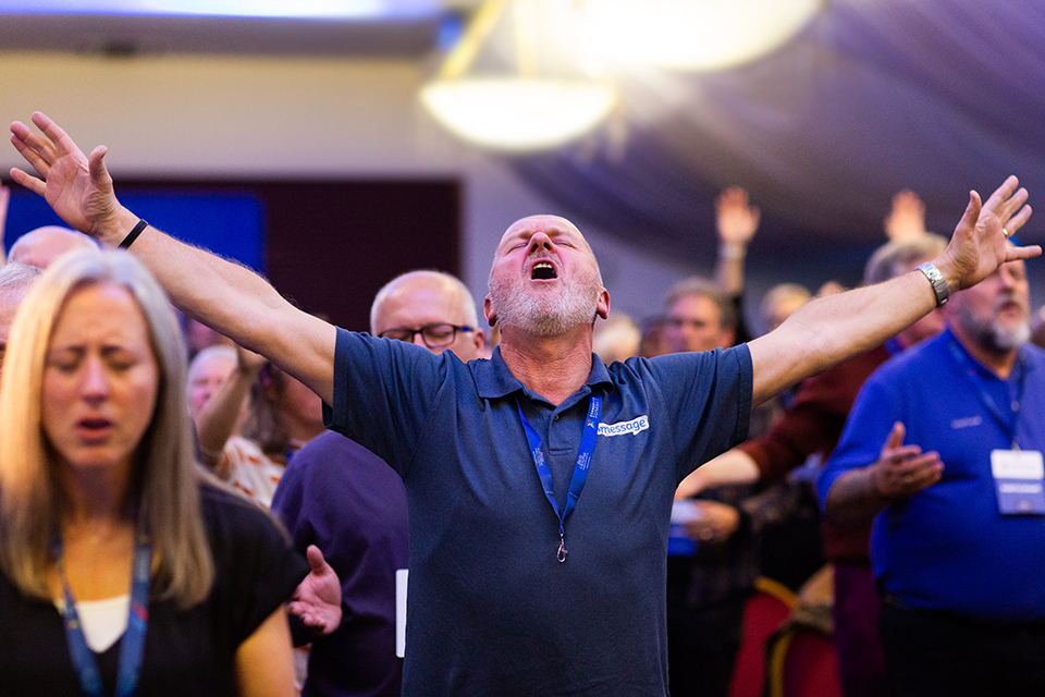 Man worshiping at UK Evangelism Summit