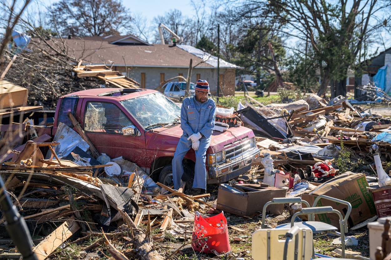 Arkansas man surrounded by destroyed remains of houses from tornado