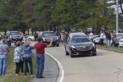 People watch as the hearse carrying the body of Billy Graham leaves Hickory, N.C., as it drives toward the Billy Graham Library Saturday, Feb. 24, 2018. Graham's body was brought to his hometown of Charlotte on Saturday, Feb. 24, as part of a procession expected to draw crowds of well-wishers. (AP Photo/Kathy Kmonicek, Pool)
