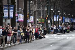 People line the street to watch the casket carrying the body of Billy Graham travel through Charlotte, N.C., Saturday, Feb. 24, 2018. Graham's body was brought to his hometown of Charlotte on Saturday, Feb. 24, as part of a procession expected to draw crowds of well-wishers. (AP Photo/Kathy Kmonicek)