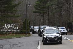 The hearse carrying the body of Billy Graham leaves the Billy Graham Training Center in Asheville, N.C., Saturday, Feb. 24, 2018. Graham's body was brought to his hometown of Charlotte on Saturday, Feb. 24, as part of a procession expected to draw crowds of well-wishers. (AP Photo/Kathy Kmonicek)