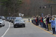 People watch as the hearse carrying the body of Billy Graham leaves Asheville, N.C., Saturday, Feb. 24, 2018. Graham's body was brought to his hometown of Charlotte on Saturday, Feb. 24, as part of a procession expected to draw crowds of well-wishers. (AP Photo/Kathy Kmonicek)