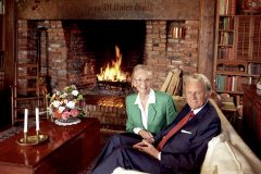 Billy and Ruth Graham at home in 1993. The German inscription on the fireplace mantel is the title of the famous hymn, "A Mighty Fortress Is Our God."