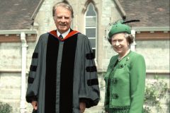 Billy Graham stands with Queen Elizabeth II in 1989. The Queen invited Graham to preach to the royal family at Windsor and Sandringham on multiple occasions.