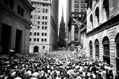During a lunch-hour meeting in the financial district of Manhattan on July 10, 1957, Billy Graham preaches from the steps of Federal Hall to a crowd of professionals standing shoulder-to-shoulder on Wall Street.