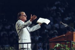 Throughout his life, Billy Graham preaches the gospel of Jesus Christ to some 215 million people in live audiences (Crusades, simulcasts and evangelistic rallies). Hundreds of millions more have been reached through television, video, film and webcasts (photo: 1980).