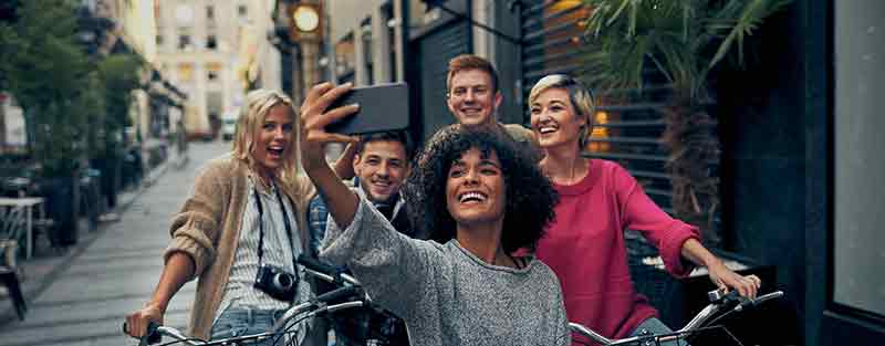 group of friends taking a selfie on bikes